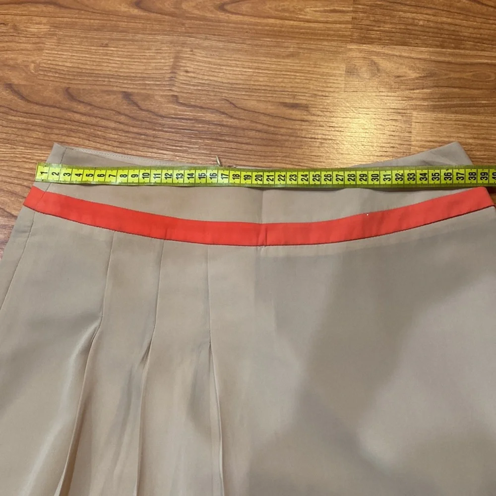 Very soft lined skirt with three pleads on the side. Size 4